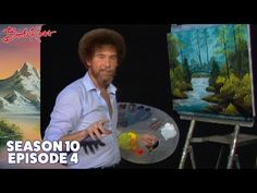 an image of bob ross holding a paintbrush in front of a painting easel