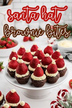 chocolate cupcakes topped with strawberries and whipped cream are on a white plate