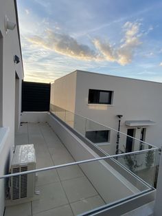 a balcony with an air conditioner on the roof and some buildings in the background