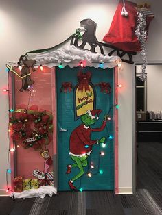 the grinch door is decorated with christmas lights and garlands, as well as decorations