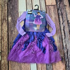 a purple and blue dress with an image of a barbie doll on it's back