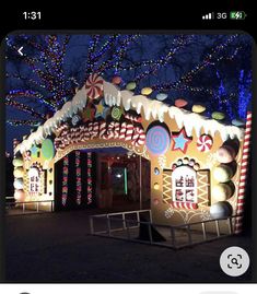 a large gingerbread house decorated with lights and candy canes