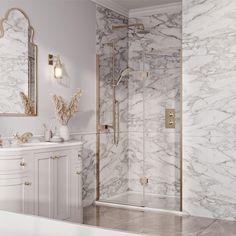 a bathroom with marble walls and flooring, including a walk in shower next to a sink