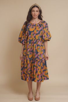 Brand: Moodie Puff sleeve midi dress with vibrant floral print. Dress has side pockets and an open back with tie. ♡ Details Color: Multi Puff sleeves Hidden side pockets Open tie back Partially lined 100% Cotton | Lining; 70% Polyester, 30% Cotton Hand wash recommended Size & Fit Model info: Height 5'3"| Bust 32"| Waist 25"| Hips 34" Model is wearing a size XS Fit: Relaxed fit Stretch: No stretch Measurements: XS: Bust = 35" | Waist = 34" | Length = 42.5" S: Bust = 36" | Waist = 35" | Length = 4 Floral Print Midi Puff Sleeve Dress For Garden Party, Floral Print Puff Sleeve Midi Dress, Garden Party Floral Print Midi Puff Sleeve Dress, Spring Floral Print Mid-length Puff Sleeve Dress, Spring Mid-length Puff Sleeve Dress With Floral Print, Puff Sleeve Midi Dress With Floral Print For Brunch, Puff Sleeve Floral Midi Dress For Brunch, Brunch Floral Print Midi Dress With Puff Sleeves, Flowy Floral Print Puff Sleeve Dress For Garden Party