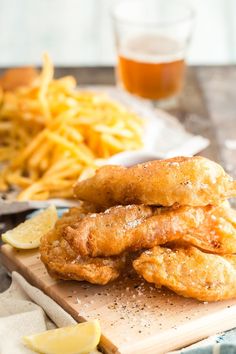 fried fish and french fries on a cutting board