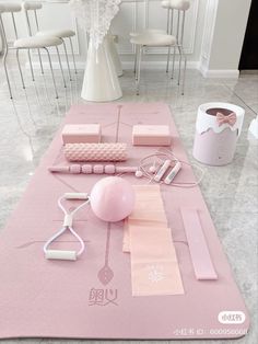 the table is set up with pink decorations and accessories on it, including a balloon