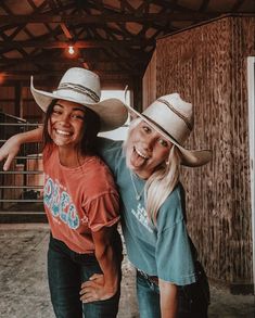 two women in cowboy hats posing for a photo