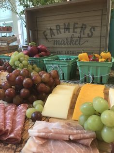 grapes, meat and cheese are on display at the farmer's market