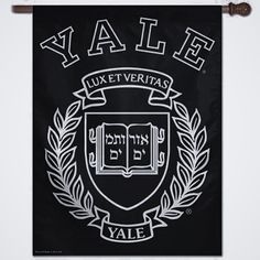 a blue banner with white lettering that reads, yale university and is hanging on a rope