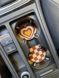 two heart shaped buttons in the center console of a car