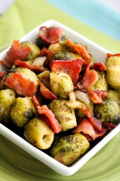 a white bowl filled with brussel sprouts and bacon