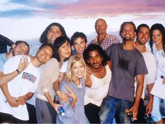 a group of people are posing for a photo with the sky in the back ground