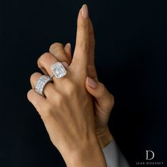 a woman's hand with two rings on it