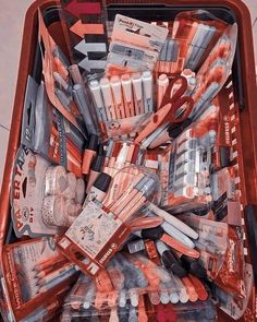 a red box filled with lots of different types of toothbrushes and other items