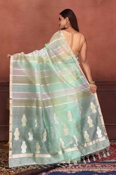 Radiate elegance on festive occasions in this alluring pastel green and zari stripes organza Banarasi saree with floral zari buta on pallu. It comes with a matching blouse piece. Disclaimer: The shown stitched blouse on the model is for display purpose only. The saree comes with a matching blouse piece and finished with fall and piko. Disclaimer: The actual product may vary slightly from the image. These are custom orders, hence expect slight variation in color, placement of the motif or buta. E Green Organza Saree With Self Design, Organza Banarasi Saree, Silk Sarees Kanchipuram, Tussar Silk Sarees, Indian Clothing Store, Latest Designer Sarees, Fashion Journals, Tussar Silk Saree, Banarasi Saree