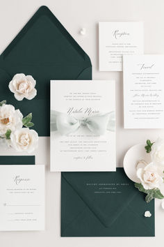 wedding stationery with white flowers and green envelope