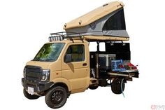 an off - road vehicle with a tent on the roof is shown in front of a white background