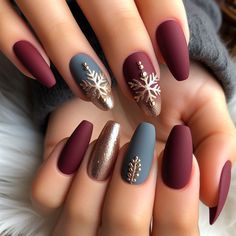 Elegant winter nail art with a matte finish in deep burgundy, adorned with gold snowflake accents December Nails Matte, Teal And Burgundy Nails, Burgundy Christmas Nail Ideas, Burgundy Nails Christmas, Winter Floral Nails, Burgundy Christmas Nails, Winter Nail Trends, Glitter Gel Nail Designs, Nail Parlour