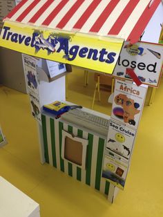 a toy store with an awning that says travel agent's closed on it