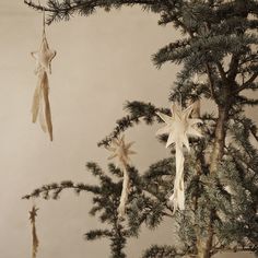 several ornaments hanging from the branches of a pine tree