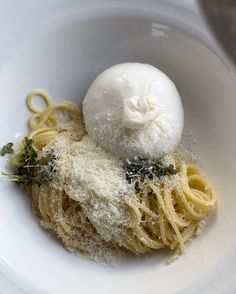 a white bowl filled with pasta and sauce