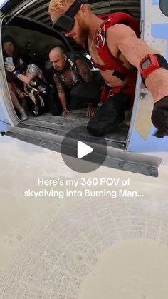 a man in red shirt and black pants standing on the back of an airplane door