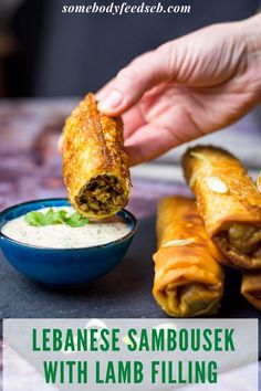 someone dipping some food in a bowl with the words leanese sambousek with lamb filling