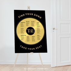 a black and gold poster with the words find your song take your seat on it