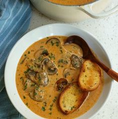 two bowls filled with soup on top of a table