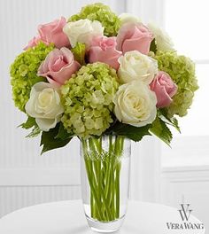 a vase filled with white and pink flowers