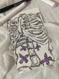 a drawing of a woman's dress with purple butterflies on it and a pen next to it