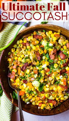 a wooden bowl filled with corn and other vegetables on top of a white table cloth