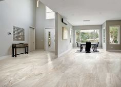 an empty dining room with white walls and wood flooring is pictured in this image