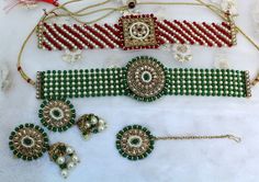 *Light Weight kundan necklace set with earrings and tikka No.1- *Necklace width- 1.1 inches(included drops) *Earrings Length- 2.9 inches (Included pearl drops) *Earrings stud diameter- 1.2 inches *No.2- *Necklace length- 1.1 inches(included drops) *Earrings length- 2.9 inches *Earrings Breadth- 1.2 inches *No.3- *Necklace length- 1.1 inches(included drops) *Earrings length- 2.8 inches *Earrings Breadth- 1.7 inches *No.4 *Necklace length- 1.1 inches(included drops) *Earrings length- 2.9 inches *E Green Chandbali Choker For Diwali, Green Choker For Diwali Celebration, Diwali Green Chandbali Choker, Diwali Celebration Green Choker, Green Bollywood Choker For Celebration, Green Stone Work Choker For Festivals, Green Kundan Choker Necklace For Diwali, Red Meenakari Choker For Diwali, Green Heavy Bollywood Choker