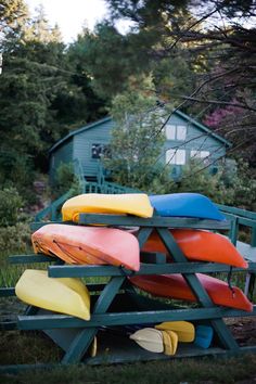 several canoes are stacked on top of each other