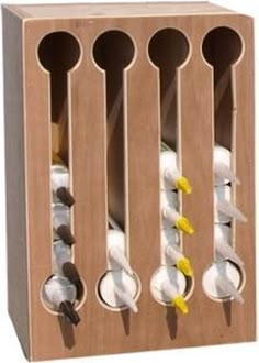 a wooden box with spoons and cups in it