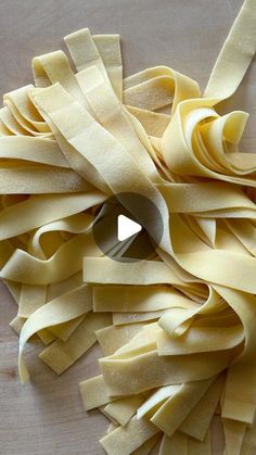 a pile of uncooked pasta sitting on top of a wooden table