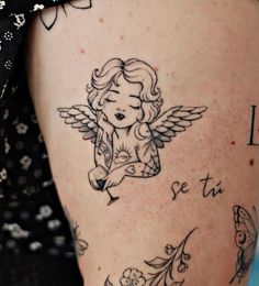 a woman's leg with an angel tattoo on the side and words written below it