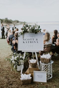 a sign that says scott and katrina sitting on top of a wooden table