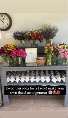 there is a table with flowers on it and a sign that says loved this idea for a favors make your own total arrangement