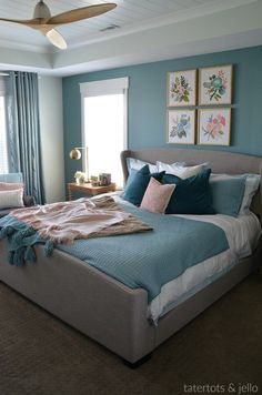 a bedroom with a bed, dresser and ceiling fan in the middle of the room