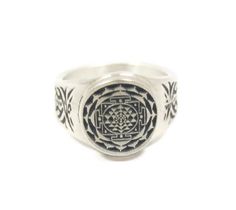 This ring was designed with the Sri Yantra or Shri Chakra symbol. Mystical diagram used in the Shri Vidya school of Hinduism.  It contains nine interlocking triangles of which 4 are for Shiva and 5 for Raj rajeshwari that surround a central point known as a bindu.  These triangles represent the cosmos and the human body. The beautiful pewter ring is a silver color and the background is blackened to bring out the fine detail of the design. Our rings are 100% Lead and nickel free pewter and made i Gold Braclate, Shri Chakra, Yggdrasil Tree, Antique Gold Rings, Pewter Ring, Shri Yantra, Chakra Symbols, Sri Yantra, Mens Gold Jewelry