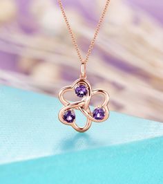 "≫≫ Item Details  Made to Order, All Handmade in the United States  Metal : Solid 14K & 18K Gold  Center Stone: Amethyst  Shape: 4 mm Round cut (3)  Pendant Size: about 24.8*16.65 mm  Pendant weight: about 3.22  g PHONE NUMBER NEEDED In order to make sure the package arrive safely. Please leave a note in the order of the Phone Number or send a message to me. Custom Service We offer any kinds of custom or personalized orders. Contact us Share with us your dream ring, design idea, and we'll make t Elegant Rose Gold Birthstone Necklace For Valentine's Day, Rose Gold Birthstone Necklace With Clavicle Chain As Gift, Rose Gold Birthstone Necklace Clavicle Chain, Rose Gold Pendant Necklace Gift For Mom, Rose Gold Pendant Necklace For Mom, Rose Gold Fine Jewelry Necklace For Mom, Rose Gold Birthstone Jewelry In Flower Shape, Rose Gold Gemstone Jewelry For Mother's Day, Rose Gold Birthstone Necklace For Anniversary Gift