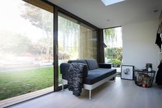 a living room filled with furniture and lots of windows