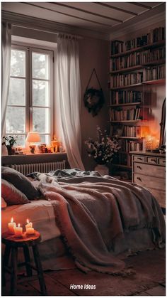 a bedroom with a bed, bookshelf and candles