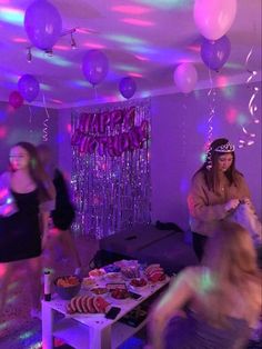 two women dancing in a party with balloons and streamers