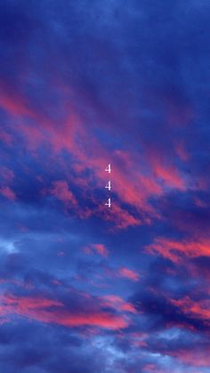 an airplane is flying in the sky at sunset or dawn with pink and blue clouds