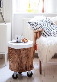 a room with a bed, chair and small table in the corner near a window