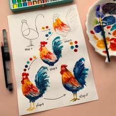 a drawing of roosters on paper next to paintbrushes and watercolor paints