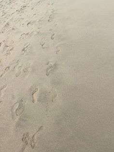 footprints in the sand at the beach